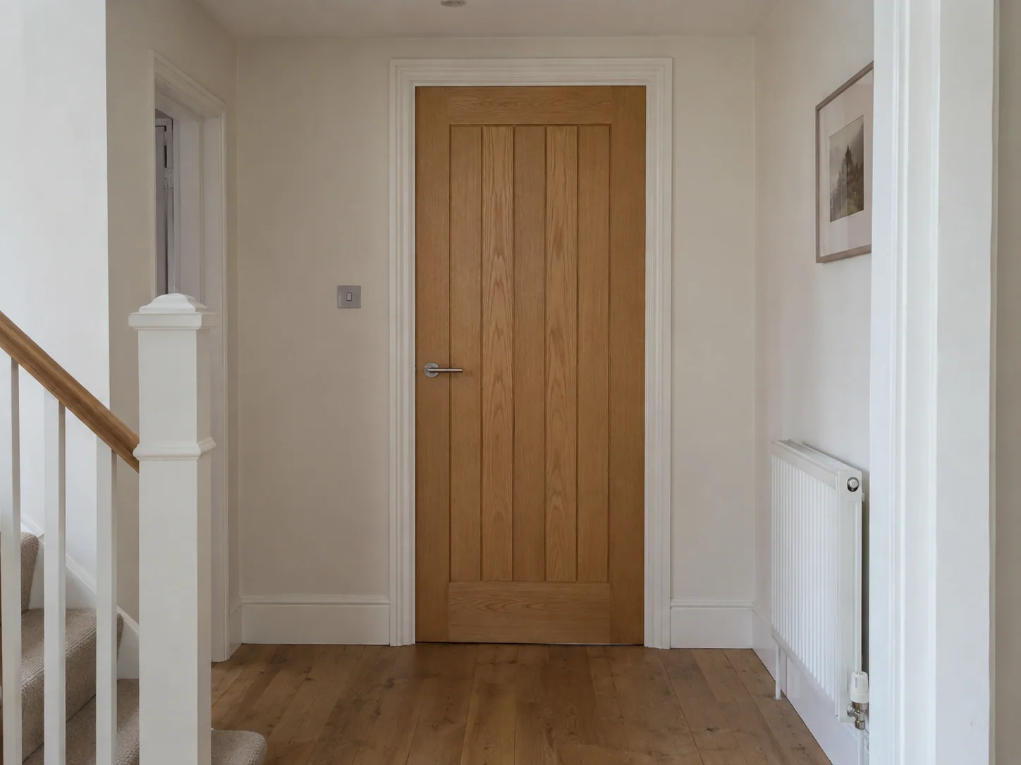 Full-height oak internal door with a fitted lever handle